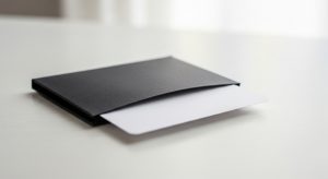 A black wallet with a white card.