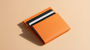An orange wallet with black and white cards.